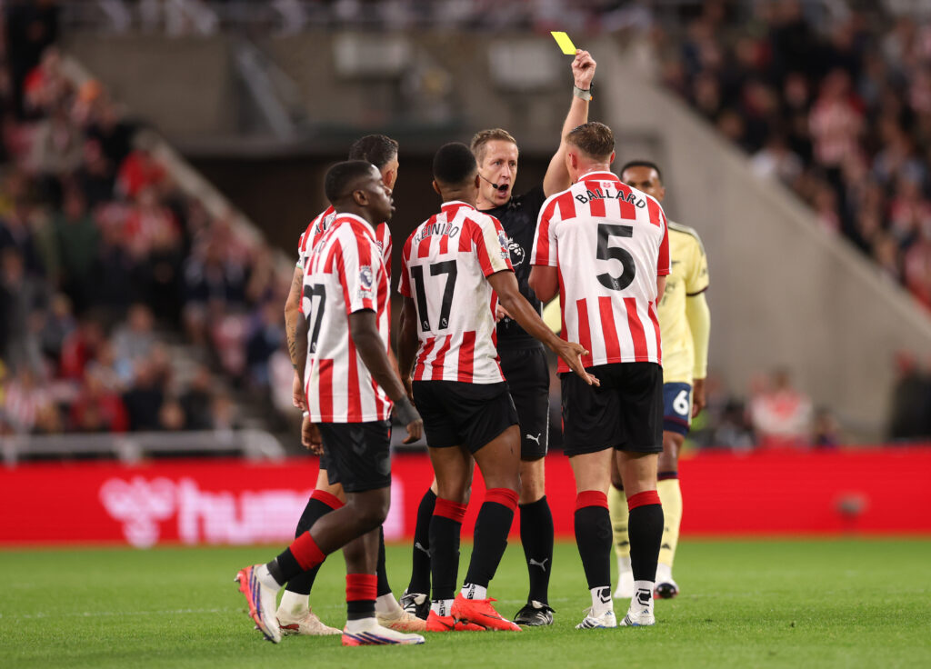 SUNDERLAND, ENGLAND - SEPTEMBER 12: Daniel Ballard of Sunderland receives a yellow card from referee John Brooks during the Premier League 2026/27 match between Sunderland and Arsenal FC at Stadium of Light on September 12, 2026 in Sunderland, England. (Photo by Stu Forster/Getty Images)