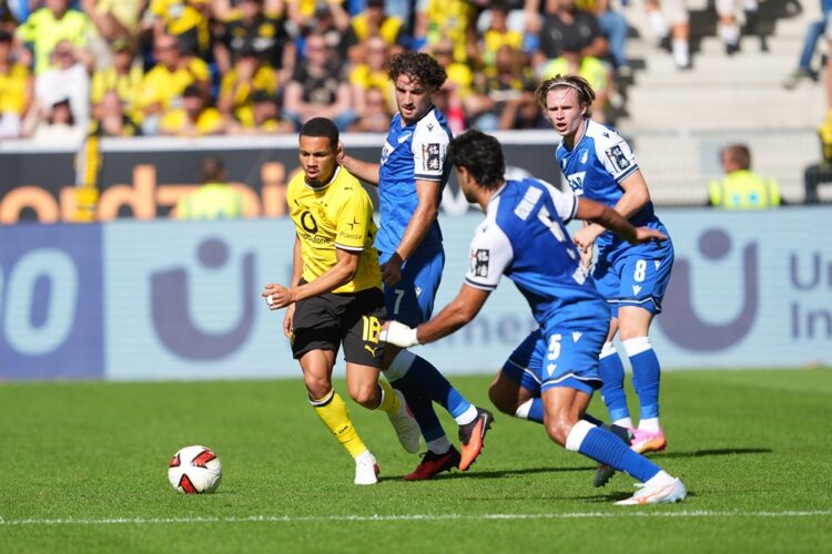 Ethan Nwaneri of Borussia Dortmund is challenged by Ozan Kabak of TSG 1899 Hoffenheim during the Bundesliga 2026/27 match between TSG Hoffenheim an...
