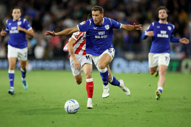 CARDIFF, WALES - SEPTEMBER 08: Krystian Bielik of Cardiff City is challenged by Bae Jun-Ho of Stoke City during the Sky Bet Championship 2026/27 ma...