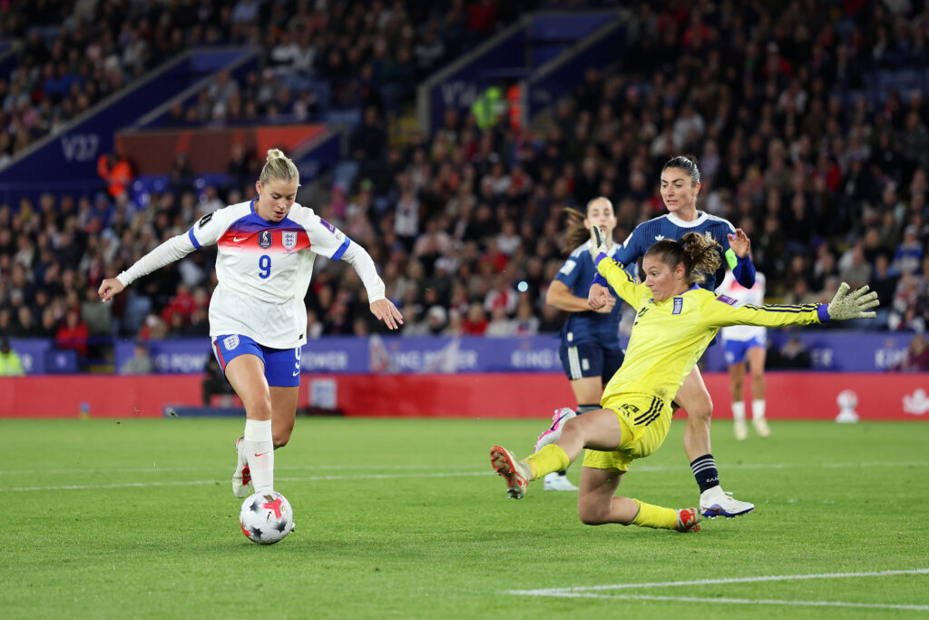 LEICESTER, ENGLAND - OCTOBER 13: Alessia Russo of England takes the ball around Styliani Katergiannaki of Greece before going on to score her team’s fifth goal during the FIFA Women's World Cup 2027 Women's European Qualifiers Play-offs Round 1: Second Leg between England and Greece at The King Power Stadium on October 13, 2026 in Leicester, England. (Photo by Morgan Harlow/Getty Images)