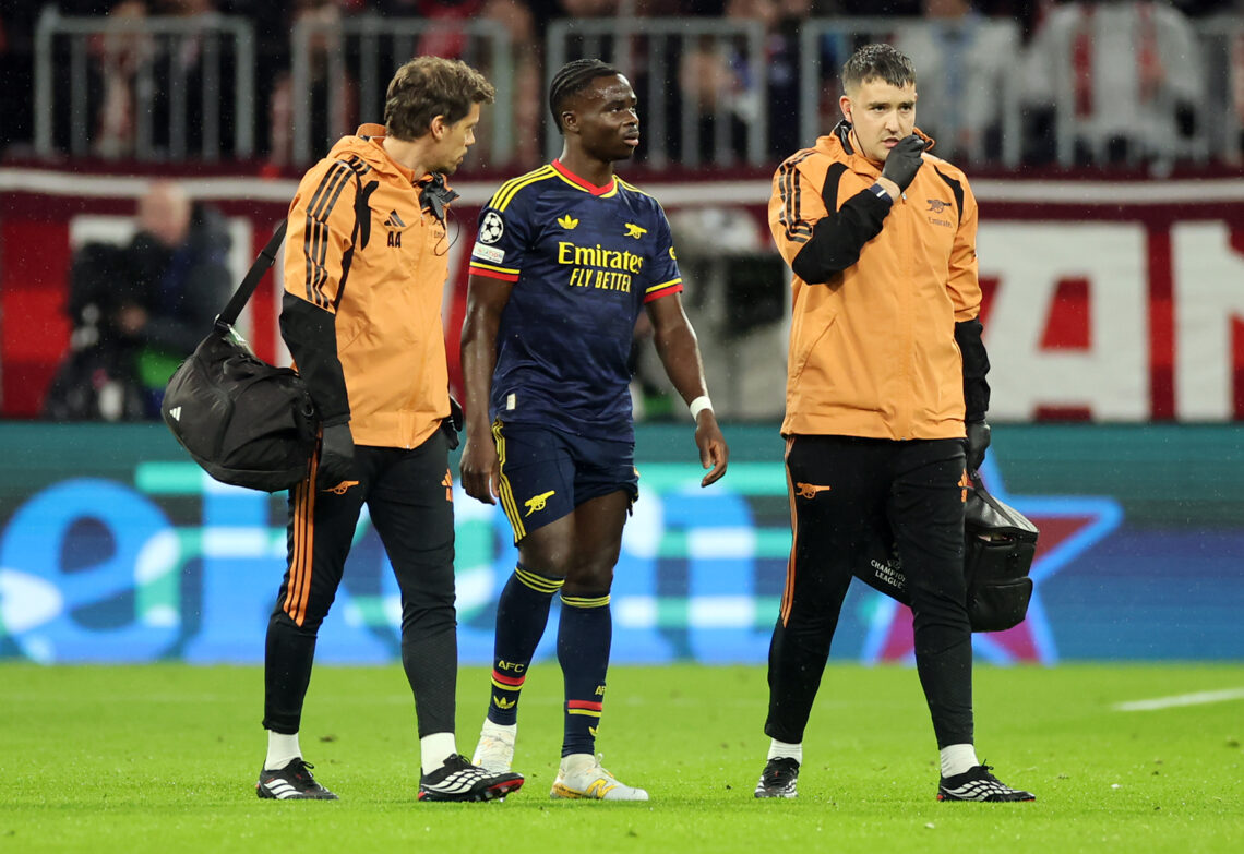 MUNICH, GERMANY - OCTOBER 21: Bukayo Saka of Arsenal receives medical attention after sustaining an injury during the UEFA Champions League 2026/27...
