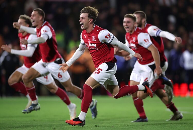 Adam Murphy of Fleetwood Town celebrates winning the penalty shootout with teammates during the Carabao Cup Fourth Round match between Fleetwood To...
