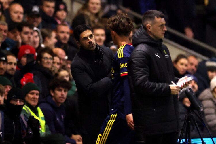 Mikel Arteta, Manager of Arsenal, talks to Max Dowman of Arsenal as he walks off the pitch after being sent off during the Carabao Cup Fourth Round...