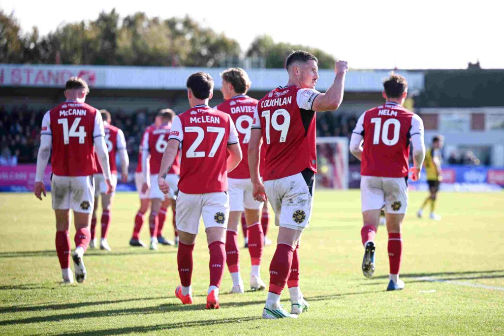FLEETWOOD, ENGLAND - OCTOBER 17: Ronan Coughlan of Fleetwood Town celebrates with teammates after scoring his team's second goal during the Sky Bet League Two 2026/27 match between Fleetwood Town and Rotherham United at Highbury Stadium on October 17, 2026 in Fleetwood, England. (Photo by Ben Roberts Photo/Getty Images)