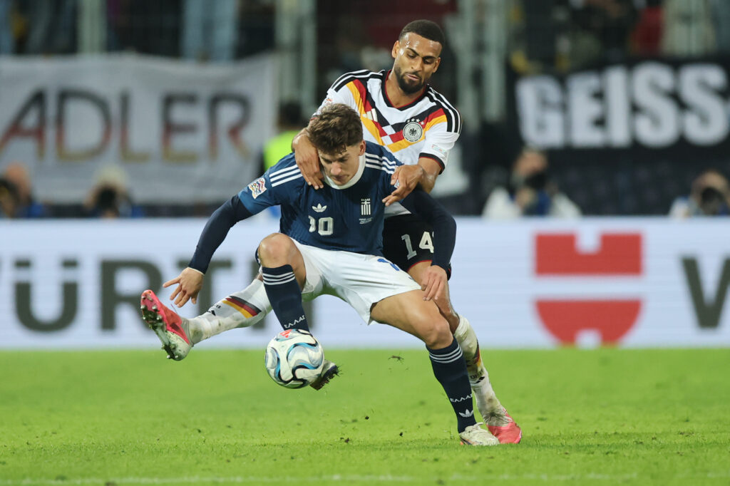 AUGSBURG, GERMANY - SEPTEMBER 27: Christos Tzolis of Greece is challenged by Josha Vagnoman of Germany during the UEFA Nations League 2026/27 group phase match between Germany and Greece at WWK Arena on September 27, 2026 in Augsburg, Germany. (Photo by Alex Grimm/Getty Images)