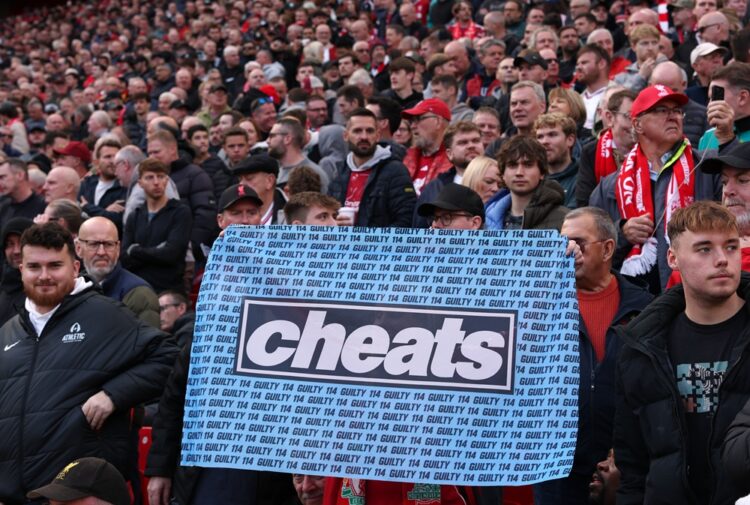 Liverpool fans hold up a flag that reads "Cheats" before the Premier League 2026/27 match between Liverpool FC and Manchester City at Anfield on Oc...