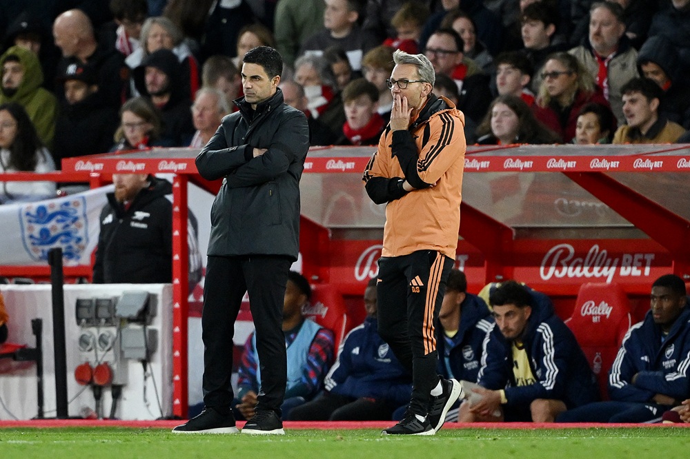 Mikel Arteta, Manager of Arsenal, and Albert Stuivenberg, Assistant Manager of Arsenal, watch on during the Premier League 2026/27 match between No...