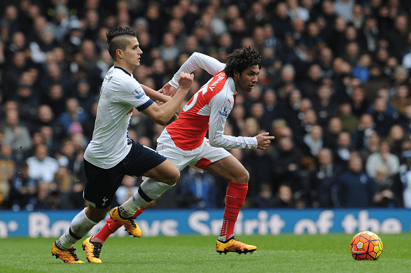 Mohamed Elneny of Arsenal takes on Erik Lamela of Tottenham during the Barclays Premier League match between Tottenham Hotspur and Arsenal at White Hart Lane on March 5, 2016 in London, England.