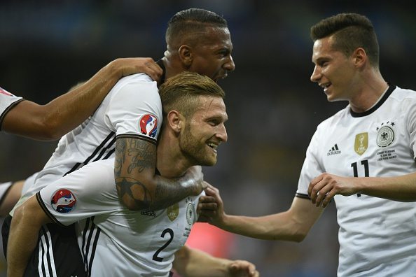 Germany's defender Shkodran Mustafi (C) celebrates with Germany's defender Jerome Boateng (L) and Germany's midfielder Julian Draxler after scoring a goal during the Euro 2016 group C football match between Germany and Ukraine at the Stade Pierre Mauroy in Villeneuve-d'Ascq near Lille on June 12, 2016. / AFP / MARTIN BUREAU (Photo credit should read MARTIN BUREAU/AFP/Getty Images)