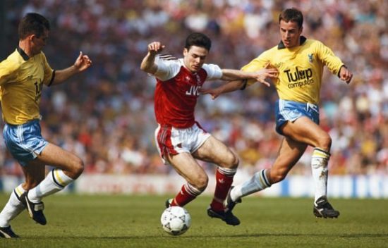 LONDON, UNITED KINGDOM - APRIL 11: Arsenal forward Anders Limpar (c) holds off the challenge of Crystal Palace defender Gareth Southgate (r) during a league Division One match at Higbury on April 11, 1992 in London, England.  (Photo by Shaun Botterill/Allsport/Getty Images)