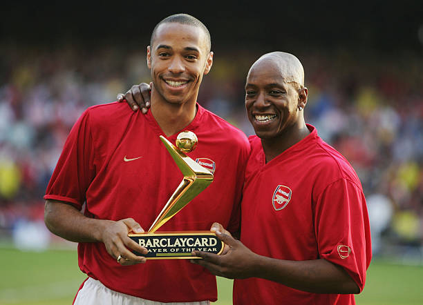 LONDON - MAY 17: Thierry Henry of Arsenal is presented with his Barclaycard Premiership Player of the Year Award by Ian Wright during the Martin Keown Testimonial match between Arsenal and England XI at Highbury, on May 17, 2004 in London. (Photo by Clive Mason/Getty Images)