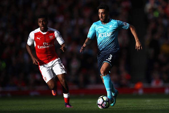 LONDON, ENGLAND - OCTOBER 15: Neil Taylor of Swansea City goes past Alex Iwobi of Arsenal during the Premier League match between Arsenal and Swansea City at Emirates Stadium on October 15, 2016 in London, England. (Photo by Julian Finney/Getty Images)
