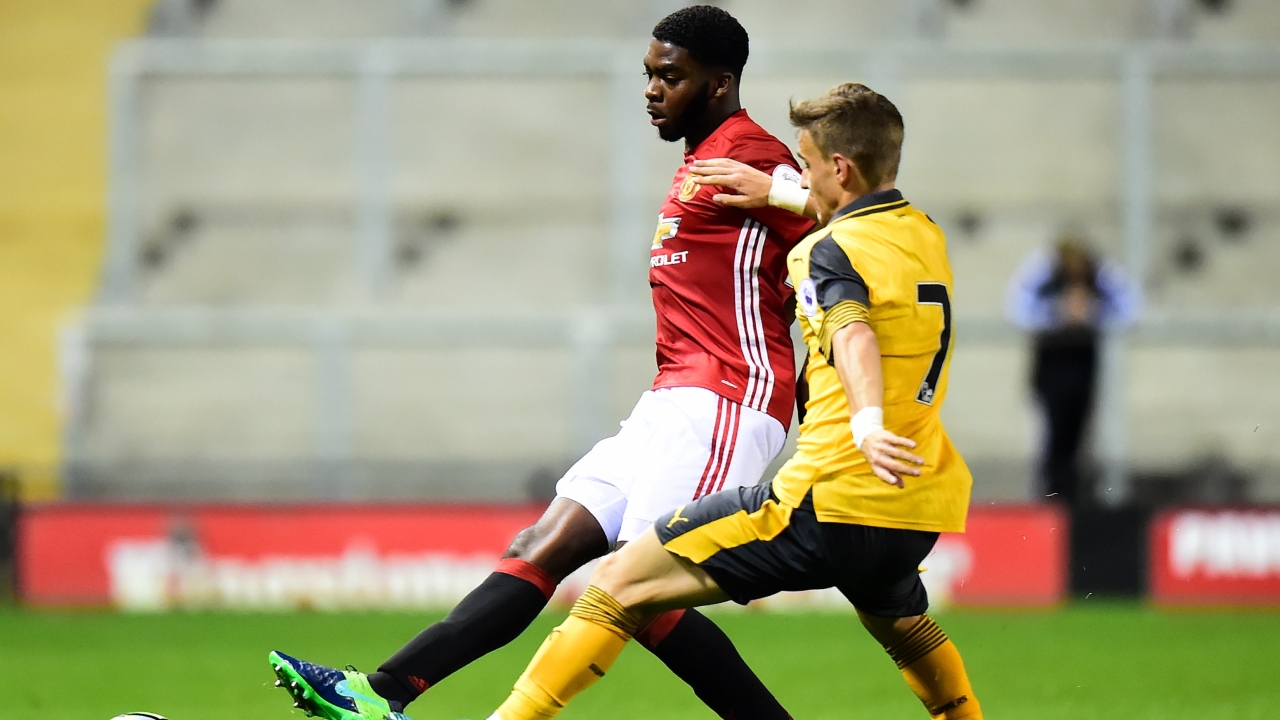 RoShaun Williams tussling with Arsenal's creative midfielder Vlad Dragomir (right) for possession (Photo source: Manchester United's official website)