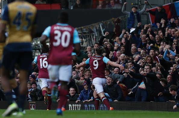 West Ham United's English striker Andy Carroll (C) celebrates scoring his team's third goal, his hat trick, during the English Premier League football match between West Ham United and Arsenal at The Boleyn Ground in Upton Park, in east London on April 9, 2016. / AFP / Ian Kington / RESTRICTED TO EDITORIAL USE. No use with unauthorized audio, video, data, fixture lists, club/league logos or 'live' services. Online in-match use limited to 75 images, no video emulation. No use in betting, games or single club/league/player publications. / (Photo credit should read IAN KINGTON/AFP/Getty Images)