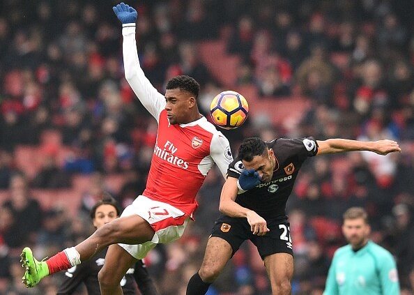 Iwobi (L) in action, battling for possession in an aerial duel against Hull City