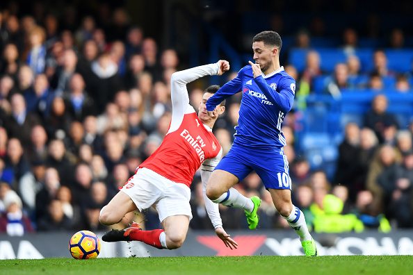 Koscielny (L) in action against Chelsea, attempting to tackle the onrushing Eden Hazard