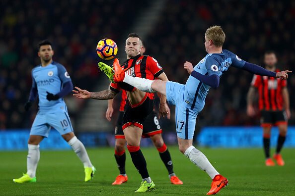 Wilshere (second left) in action against Manchester City