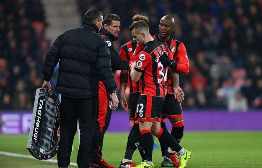 Wilshere (C) limps off just before half-time against Manchester City