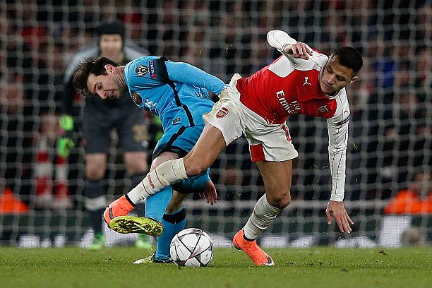 Alexis (R) in action against former teammate Messi during last season's Champions League last-16 tie