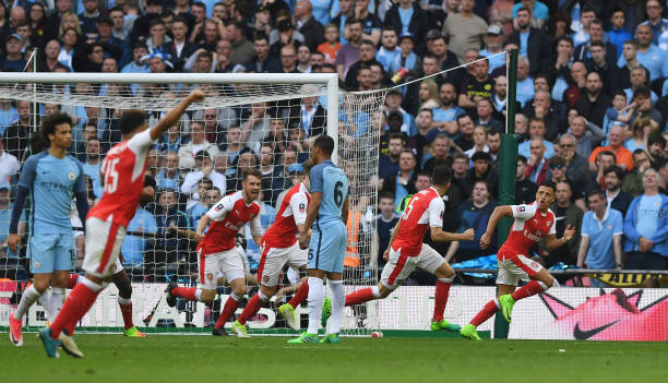 Alexis (far right) celebrates the eventual winner against City on Sunday