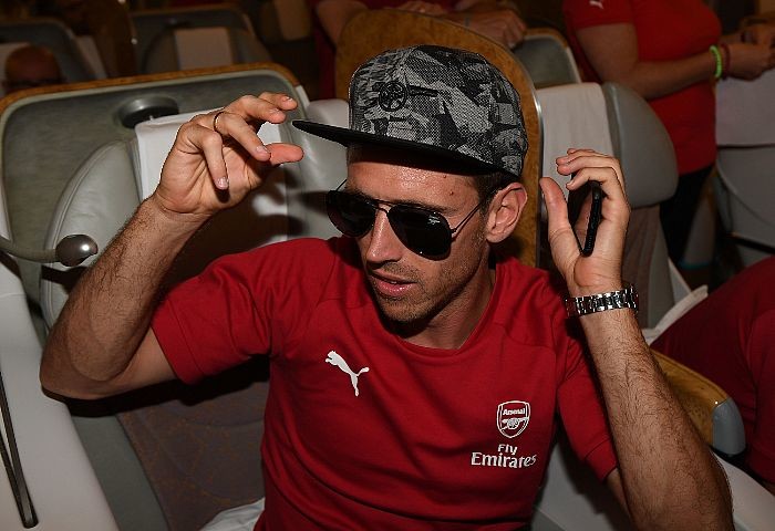 LONDON, ENGLAND - JULY 09: Nacho Monreal of Arsenal checks out his new Puma snapback as the team prepares to fly off for pre season tour at Stansted Airport on July 9, 2017 in London, England. (Photo by David Price/Arsenal FC via Getty Images)