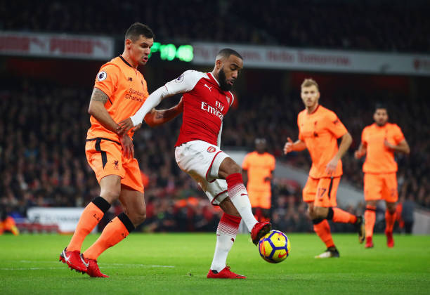 Alexandre Lacazette of Arsenal shields the ball from Dejan Lovren of Liverpool during the Premier League match between Arsenal and Liverpool at Emirates Stadium on December 22, 2017 in London, England. (Photo by Julian Finney/Getty Images)