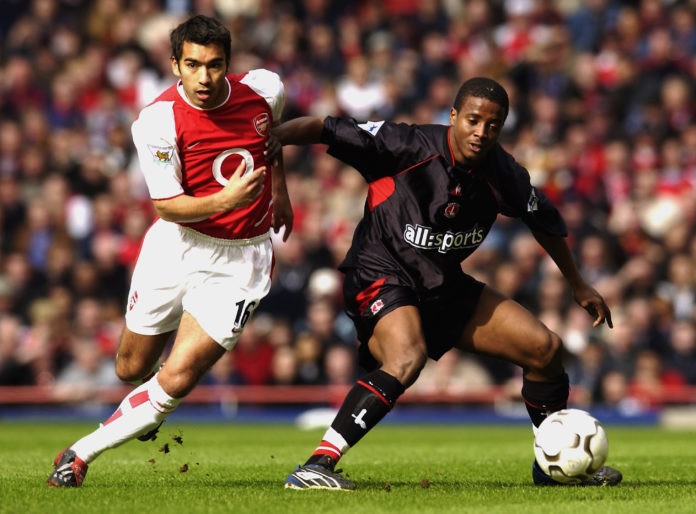 LONDON - MARCH 2: Kevin Lisbie of Charlton Athletic shields the ball from Giovanni van Bronckhorst of Arsenal during the FA Barclaycard Premiership match held on March 2, 2003 at Highbury, in London. Arsenal won the match 2-0. (Photo by Jamie McDonald/Getty Images)