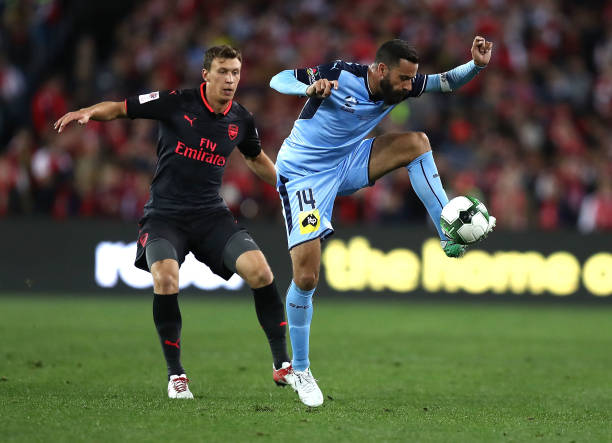 SYDNEY, AUSTRALIA - JULY 13: Alex Brosque of Sydney FC controls the ball over Krystian Bielik of Arsenal during the match between Sydney FC and Arsenal FC at ANZ Stadium on July 13, 2017 in Sydney, Australia. (Photo by Ryan Pierse/Getty Images)