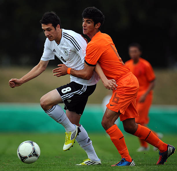 HAMELN, GERMANY - SEPTEMBER 12: Levin Oeztunali of Germany is challenged by Rewan Amin Mohammed of Netherlands during the Under 17 KOMM MIT 4-Nations tournament match between Germany and Netherlandsat Weserbergland stadium on September 12, 2012 in Hameln, Germany. (Photo by Lars Baron/Bongarts/Getty Images)