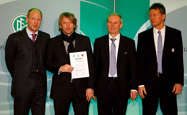 COLOGNE, GERMANY - MARCH 17: Sven Mislintat (2nd L) receives his DFB Football Trainer Certificate from Matthias Sammer (L), Rainer Milkoreit (2nd R) and Frank Wormuth (R) at the hotel Wasserturm on March 17, 2011 in Cologne, Germany. (Photo by Friedemann Vogel/Bongarts/Getty Images)