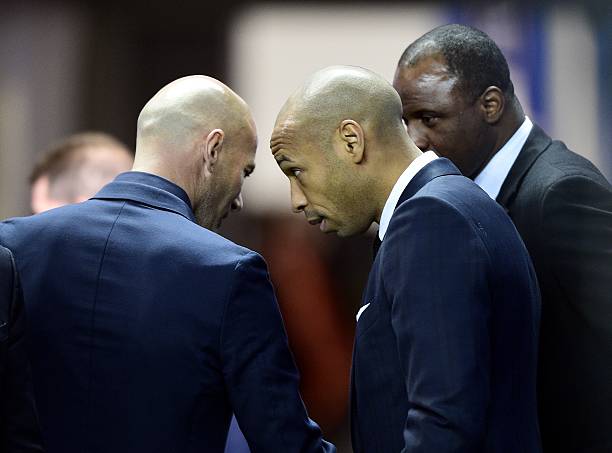 (From L) Former French international football players Zinedine Zidane speaks with Thierry Henry and Patrick Vieira before a ceremony honouring French former international football players with more than hundred caps ahead of the friendly football match France vs Brazil, on March 26, 2015 at the Stade de France in Saint-Denis, north of Paris. AFP PHOTO / FRANCK FIFE 
