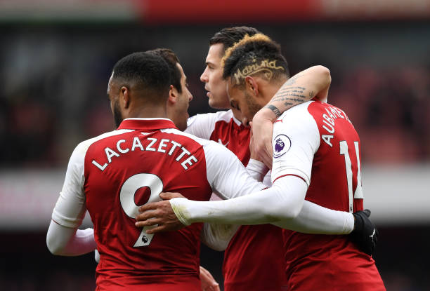 LONDON, ENGLAND - APRIL 01: Pierre-Emerick Aubameyang of Arsenal celebrates after scoring his sides second goal with Alexandre Lacazette of Arsenal and his team mates during the Premier League match between Arsenal and Stoke City at Emirates Stadium on April 1, 2018 in London, England. (Photo by Shaun Botterill/Getty Images)
