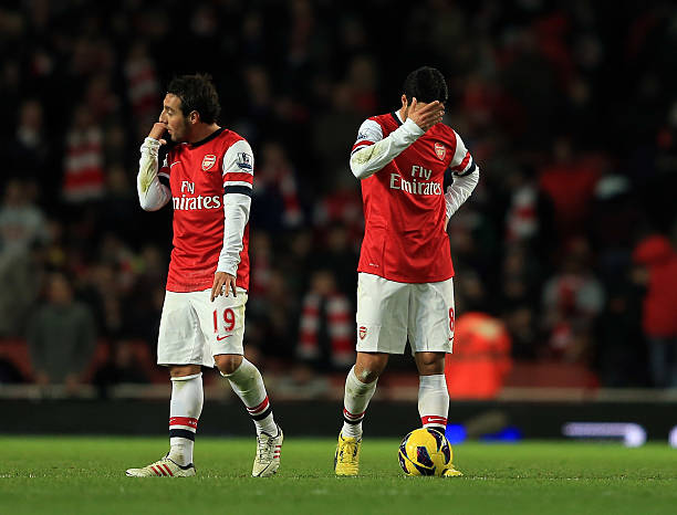 ONDON, ENGLAND - DECEMBER 01: Santi Cazorla and Mikel Arteta of Arsenal look dejected as Swansea celebrate during the Barclays Premier League match between Arsenal and Swansea City at the Emirates Stadium on December 1, 2012 in London, England. (Photo by Richard Heathcote/Getty Images)