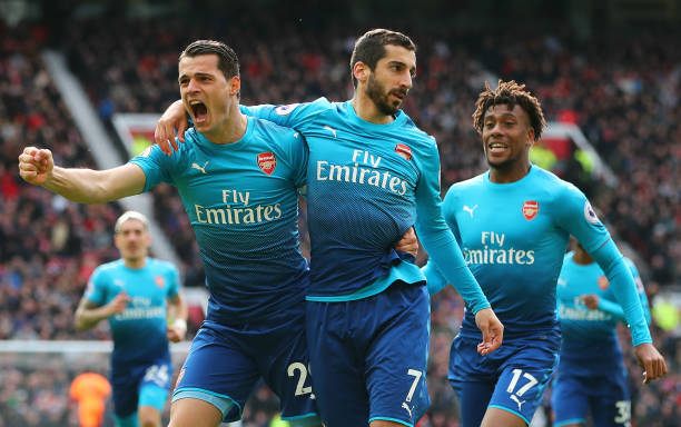 MANCHESTER, ENGLAND - APRIL 29: Henrikh Mkhitaryan of Arsenal celebrates after scoring his sides first goal with Granit Xhaka of Arsenal and Alex Iwobi of Arsenal during the Premier League match between Manchester United and Arsenal at Old Trafford on April 29, 2018 in Manchester, England. (Photo by Clive Brunskill/Getty Images)