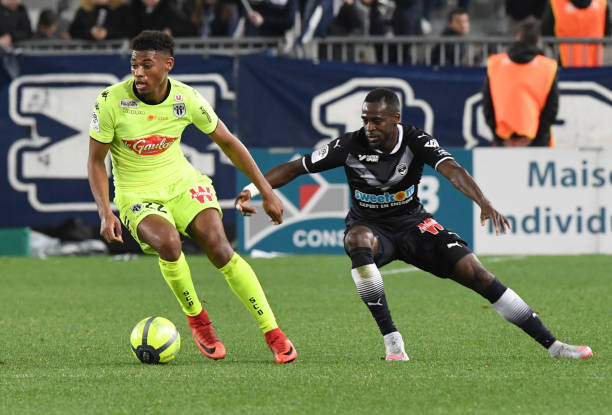 Bordeaux's French defender Maxime Poundje (R) vies with Angers' French midfielder Jeff Reine-Adelaide during French L1 football match between Bordeaux (FCGB) and Angers (SCO) on March 10, 2018, at the Matmut Atlantique Stadium in Bordeaux, southwestern France. / AFP PHOTO / MEHDI FEDOUACH