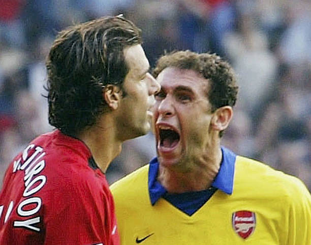 MANCHESTER, ENGLAND - SEPTEMBER 21: Martin Keown of Arsenal shows his feelings at Ruud Van Nistelrooy of Man Utd after Van Nistelrooy missed his penalty during the FA Barclaycard Premiership match between Manchester United and Arsenal at Old Trafford on September 21, 2003 in Manchester, England. (Photo by Shaun Botterill/Getty Images)