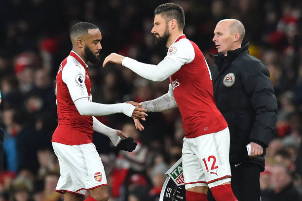 Arsenal's French striker Alexandre Lacazette (L) is substituted for Arsenal's French striker Olivier Giroud during the English Premier League football match between Arsenal and Newcastle United at the Emirates Stadium in London on December 16, 2017. / AFP PHOTO / Glyn KIRK