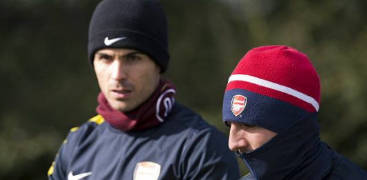 Arsenal's Spanish midfielder Mikel Arteta (L) and Arsenal's Spanish midfielder Santi Cazorla (R) walk to the pitch for a training session at the club's complex in London Colney on March 12, 2013 ahead of the team's last 16 UEFA Champions League football match against Bayern Munich in Germany on March 13. AFP PHOTO / ADRIAN DENNIS