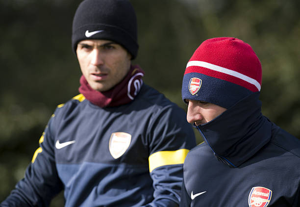 Arsenal's Spanish midfielder Mikel Arteta (L) and Arsenal's Spanish midfielder Santi Cazorla (R) walk to the pitch for a training session at the club's complex in London Colney on March 12, 2013 ahead of the team's last 16 UEFA Champions League football match against Bayern Munich in Germany on March 13. AFP PHOTO / ADRIAN DENNIS