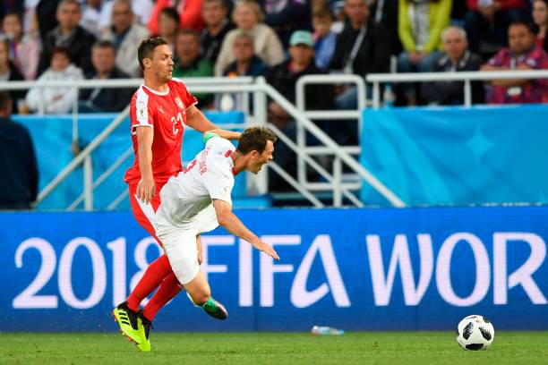 Serbia's midfielder Nemanja Matic (L) fouls Switzerland's defender Stephan Lichtsteiner during their Russia 2018 World Cup Group E football match between Serbia and Switzerland at the Kaliningrad Stadium in Kaliningrad on June 22, 2018. (Photo by OZAN KOSE / AFP)
