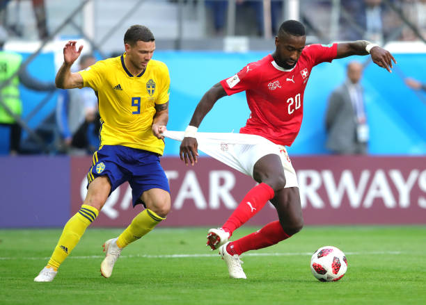 SAINT PETERSBURG, RUSSIA - JULY 03: Marcus Berg of Sweden holds back Johan Djourou of Switzerland during the 2018 FIFA World Cup Russia Round of 16 match between Sweden and Switzerland at Saint Petersburg Stadium on July 3, 2018 in Saint Petersburg, Russia. (Photo by Alexander Hassenstein/Getty Images)
