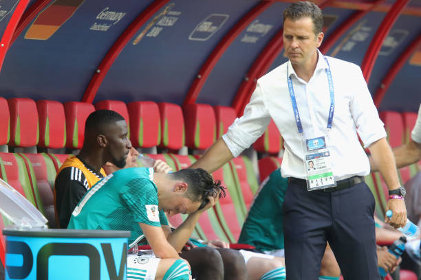 KAZAN, RUSSIA - JUNE 27: Oliver Bierhoff, team manager of Germany and his player Mesut Oezil look dejected after the 2018 FIFA World Cup Russia group F match between Korea Republic and Germany at Kazan Arena on June 27, 2018 in Kazan, Russia. (Photo by Alexander Hassenstein/Getty Images, )