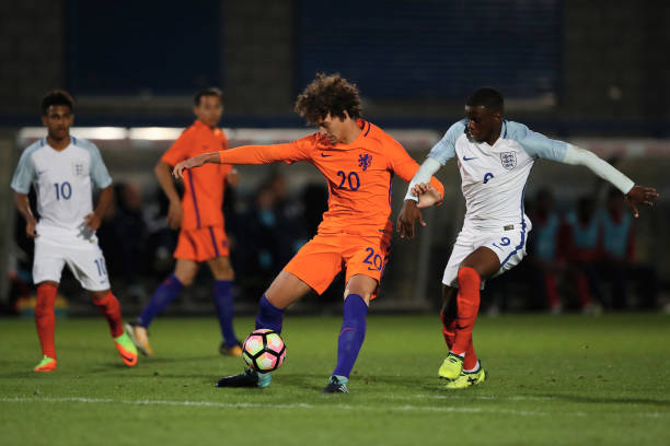 TELFORD, ENGLAND - AUGUST 31: Philippe Sandler of Netherlands and Stephy Mavididi of England in a challenge for the ball during the international match between England U20 v Netherlands U20 at New Bucks Head Stadium on August 31, 2017 in Telford, England.