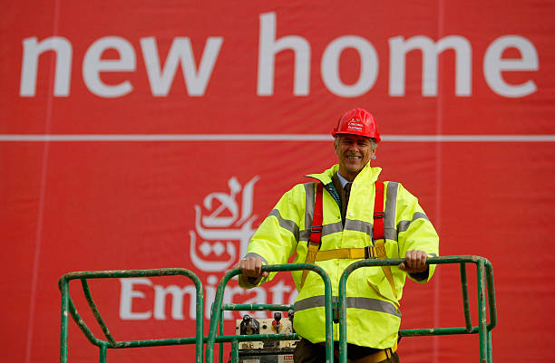 LONDON - OCTOBER 5: Manager Arsene Wenger of Arsenal poses outside Arsenal Football Club's new Emirates Stadium development at Ashburton Grove on October 5, 2004 in London. Arsenal have just announced the stadium will be called the Emirates Stadium for the next fifteen years after signing a new sponsorship deal with Emirates. (Photo by Paul Gilham/Getty Images)