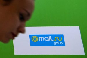 A woman passes the logo of Mail.Ru Group, one of Russia's biggest Internet companies, during the 10th Russian Internet Week in Moscow on November 1, 2017. / AFP PHOTO / Kirill KUDRYAVTSEV