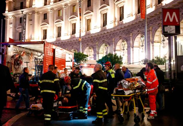 First responders evacuate wounded persons on Piazza della Repubblica in central Rome on October 23, 2018 after around 20 people were injured when an escalator leading to the Repubblica metro station collapsed in an accident believed to have been caused by Russian football fans. (Photo by Cecilia FABIANO / AFP)        (Photo credit should read CECILIA FABIANO/AFP/Getty Images)