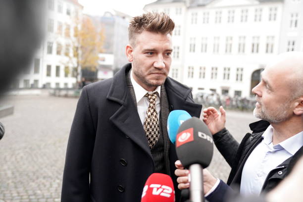 Rosenborg's Danish football player Nicklas Bendtner and lawyer Anders Nemeth talk to the media as they arrive for a hearing at Copenhagen City Council on November 2, 2018. - Nicklas Bendtner has been charged with violence against a taxi driver in Copenhagen while the driver has been charged with attempted violence. (Photo by Martin Sylvest / Ritzau Scanpix / AFP) / Denmark OUT (Photo credit should read MARTIN SYLVEST/AFP/Getty Images)