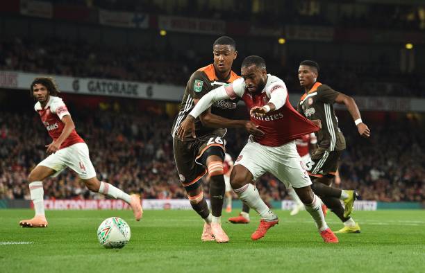 Brentford's English defender Ezri Konsa vies with Arsenal's French striker Alexandre Lacazette during the English League Cup third round football match between Arsenal and Brentford at the Emirates Stadium in London on September 26, 2018. (Photo by Glyn KIRK / AFP)