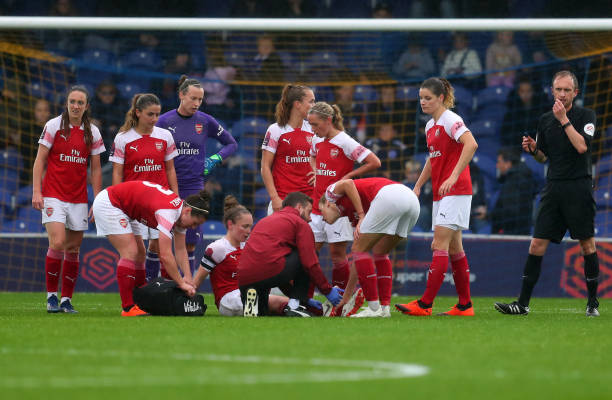 KINGSTON UPON THAMES, ENGLAND - OCTOBER 14: Kim Little of Arsenal is treated for an injury after being tackled by Drew Spence of Chelsea during the FA WSL match between Chelsea Women and Arsenal at The Cherry Red Records Stadium on October 14, 2018 in Kingston upon Thames, England. (Photo by Catherine Ivill/Getty Images)