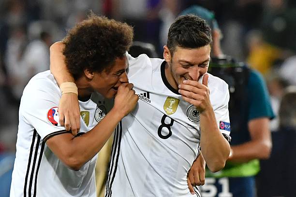 Germany's midfielder Mesut Oezil (R) and Germany's midfielder Leroy Sane celebrate after winning the Euro 2016 quarter-final football match between Germany and Italy at the Matmut Atlantique stadium in Bordeaux on July 2, 2016. / AFP / GEORGES GOBET (Photo credit should read GEORGES GOBET/AFP/Getty Images)